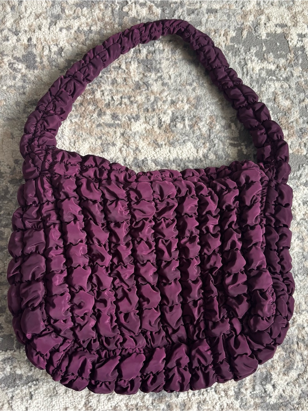 Women’s purple quilted hobo bag